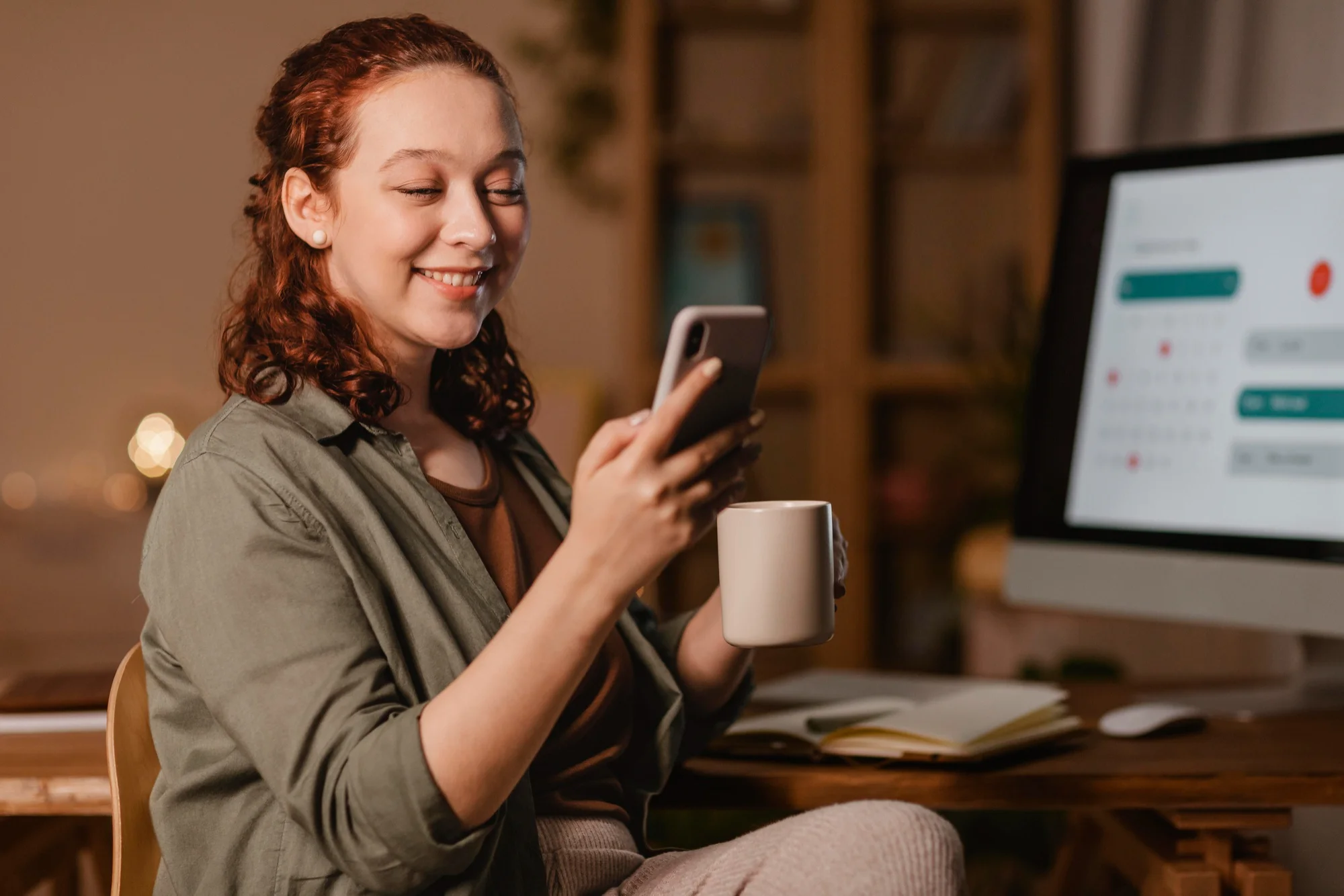 Women using phone with a cup of drink 